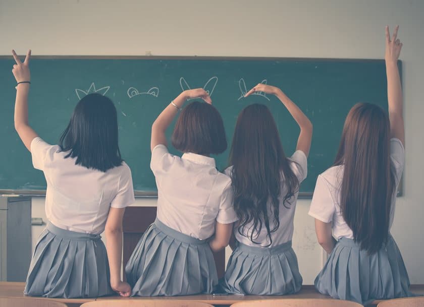 4 girls in a classroom posing