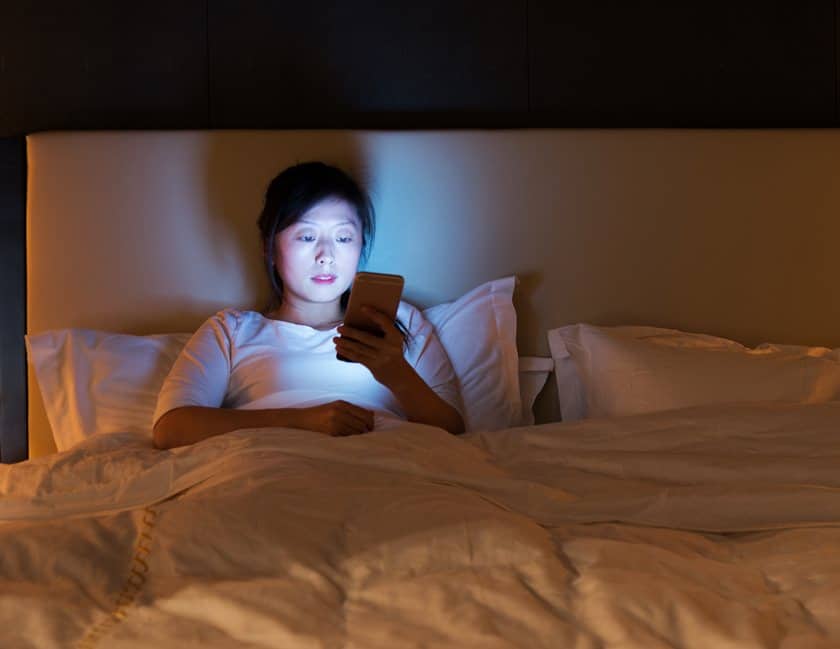 Women on her phone in bed