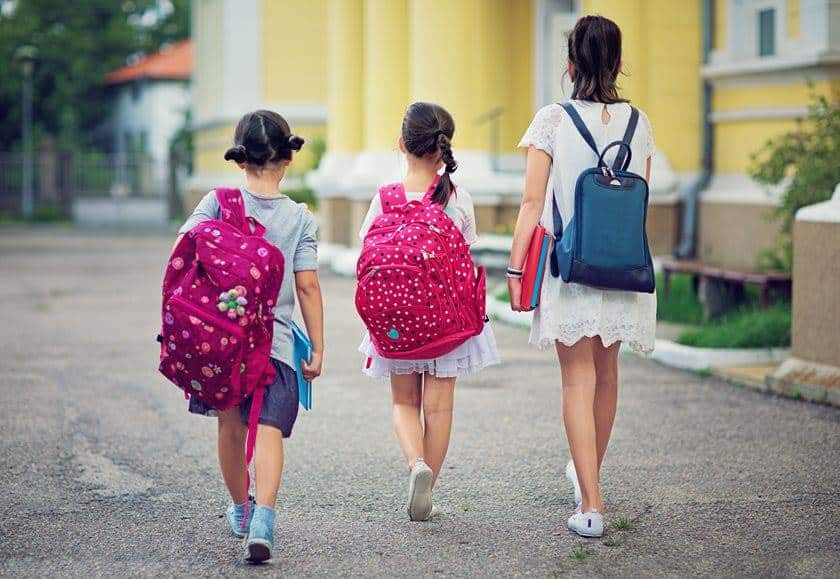 three children walking to school