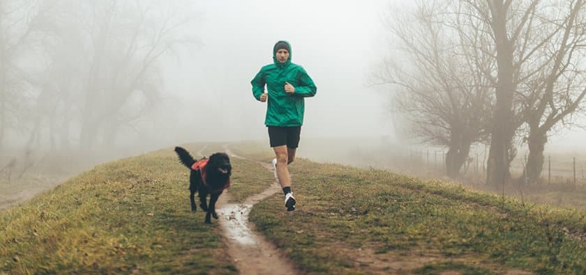 Guy running with his dog